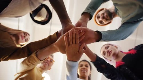 Diverse Young Professionals Join Hands in Unity