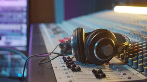 Headphones on Mixing Console in Recording Studio