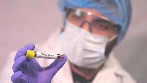 Hand holds COVID-19 test sample, negative result