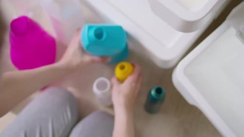 Adult Sorting Cleaning Supplies into Storage Bins