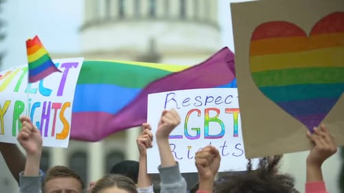 Group Protesting with Pride Flags and Signs