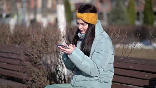 Young Woman Texting on the Smartphone