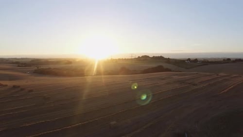 Golden Sunrise Over Harvested Fields, Aerial View