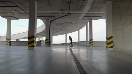 Young Boxer Train in a Parking Garage Battle with the Shadow