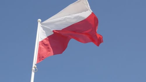 Flag Waving Against Clear Blue Sky