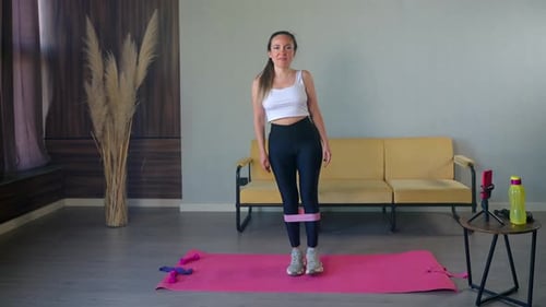 Young Woman Doing Leg Exercise with Resistance Band