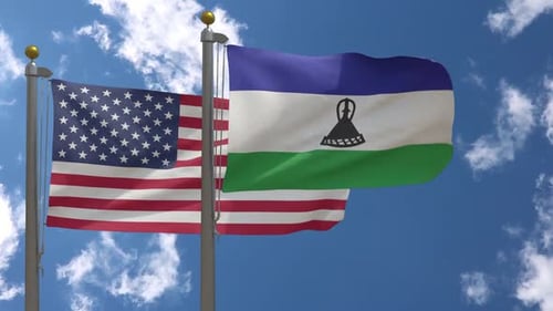 Flags of USA and Lesotho Waving Together in Blue Sky
