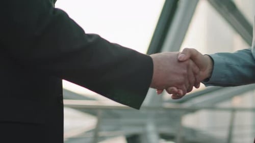 Business Handshake in a Bright Office
