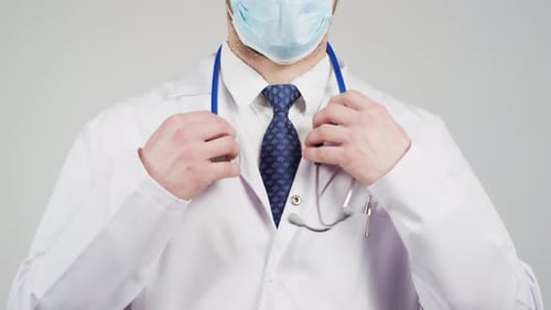 Medical Professional Putting on Stethoscope Wearing Mask