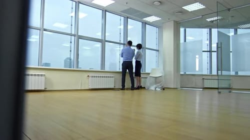 Colleagues Speaking and Drinking Coffee in New Empty Office