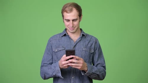 Young Happy Man Smiling While Using Phone