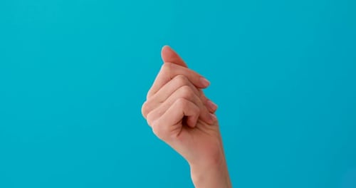 Hand Gesturing Against a Blue Background