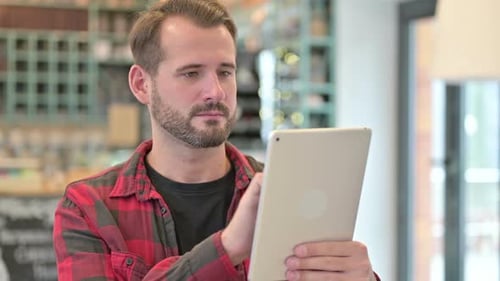 Man Using Tablet Device Indoors