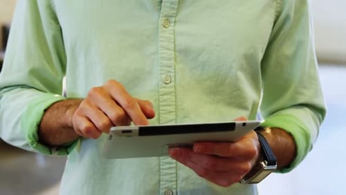 Man Using Tablet Device at Workplace