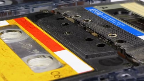 Four Audio Cassettes Rotate on White Background