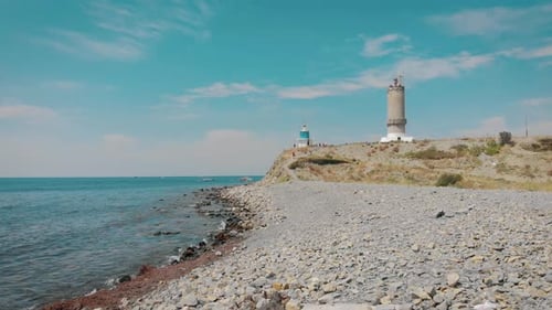 Aerial View of Lighthouse at Sea on Coastline.