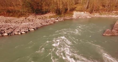 Low Altitude Flight Over Fresh Fast Mountain River with Rocks at Sunny Summer Morning