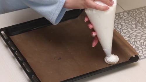 A Woman Makes Meringue For A Cake. With A Pastry Bag. Cake Count Ruins From Meringue. Close Up.