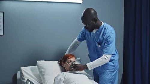 Nurse Attends Patient with Oxygen Mask in Hospital
