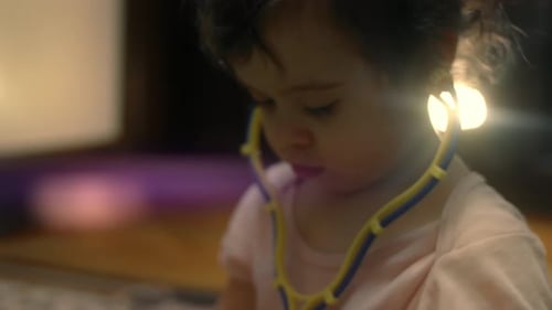Closeup View of Cute Little Girl Playing Doctor with Toy Medical Tools