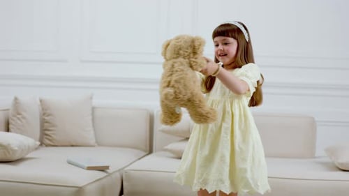 Girl Playing with Teddy Bear