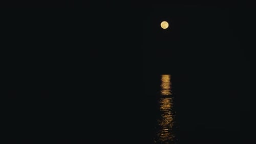 Crescent Moon Reflected in the Calm Relaxing Sea in the Night