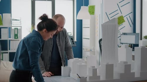 Team of Colleagues Using Building Model for Inspiration to Design Construction Layout