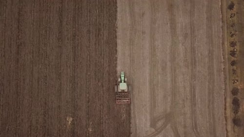 Tractor Tilling Field on Farm Aerial View