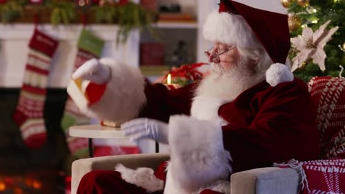 Santa Claus Relaxing Fireside Reading a Letter