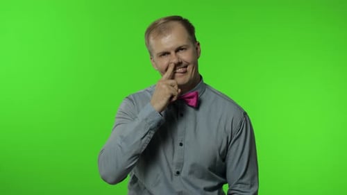 Man With Bow Tie Sticking Finger in Nose