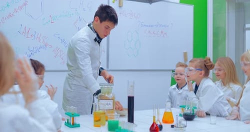 Teacher Demonstrating Chemistry to Students in Classroom