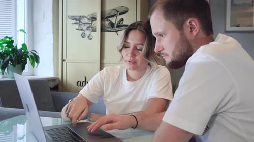 Stay home. Beautiful couple at home. Man work at home, he is in freelance during quarantine