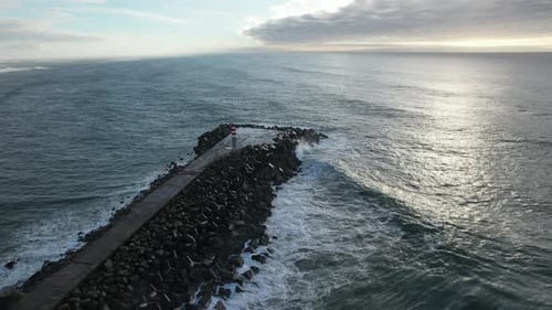 Aerial View of Pier with Lighthouse and Waves