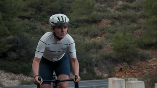 Young Motivated Female Cyclist on Road Training