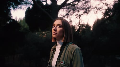Girl in the forest looking at nature, Handheld, mid shot