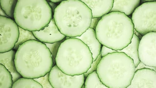 Slow Motion of Rotation Ripe Green Sliced Cucumbers