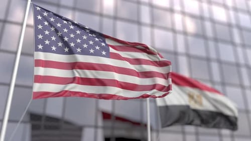 Waving Flags of the USA and Egypt in Front of Modern Skyscraper