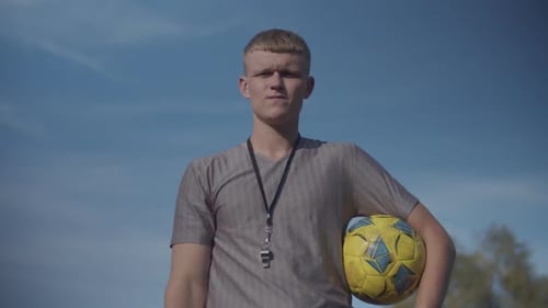 Soccer Referee with Red Card Sending Off Player