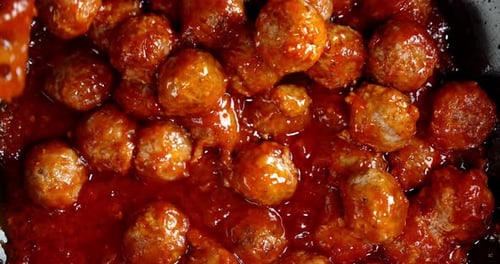 Meatballs Covered in Red Sauce Stirred in Pan