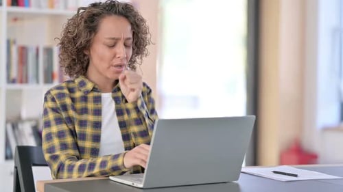 Woman Working at Computer Coughs