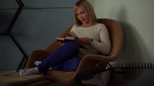 Woman at Home, Reading Book, Sitting on Chair in Living Room, Calm Weekend Alone