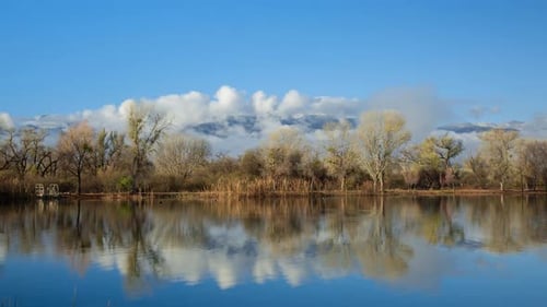 Scenic Lake with Clouds and Mountain Time Lapse Zoom In