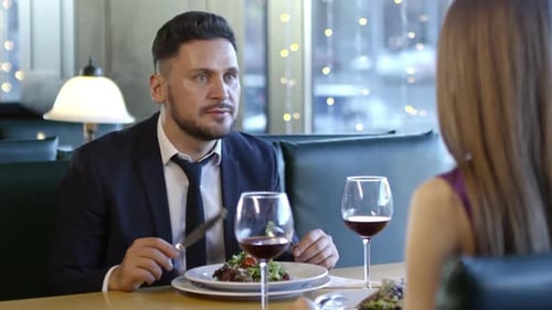Man Chatting with Woman on First Date in Restaurant