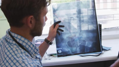 Doctor Explains X-Ray to Patient in Medical Setting