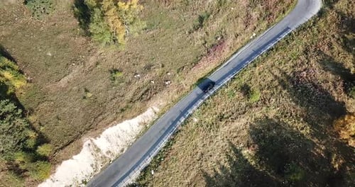 The Car Is Driving on a Road in the Forest