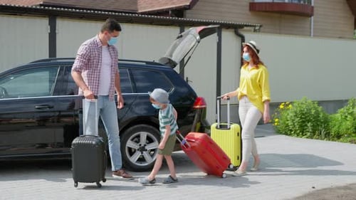 Family Weekend, Portrait of Joyful Friendly Family in Medical Masks with Suitcases Gathered To Go on