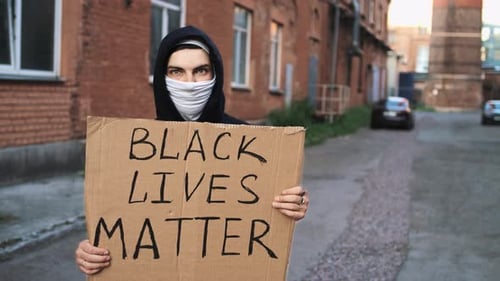 Hooded Person Holding Black Lives Matter Sign