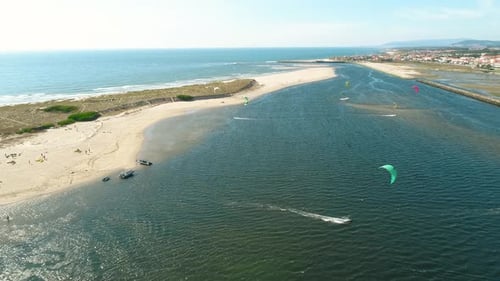 Aerial View of Kitesurfers on Beachfront Ocean