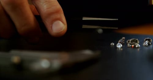 Close-up of goldsmith examining diamond