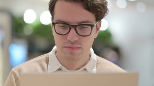 Close Up of Man Working on Laptop